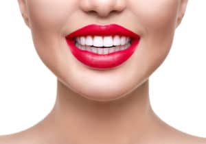 eeth whitening. Healthy white smile closeup. Beautiful girl with red lips isolated on white